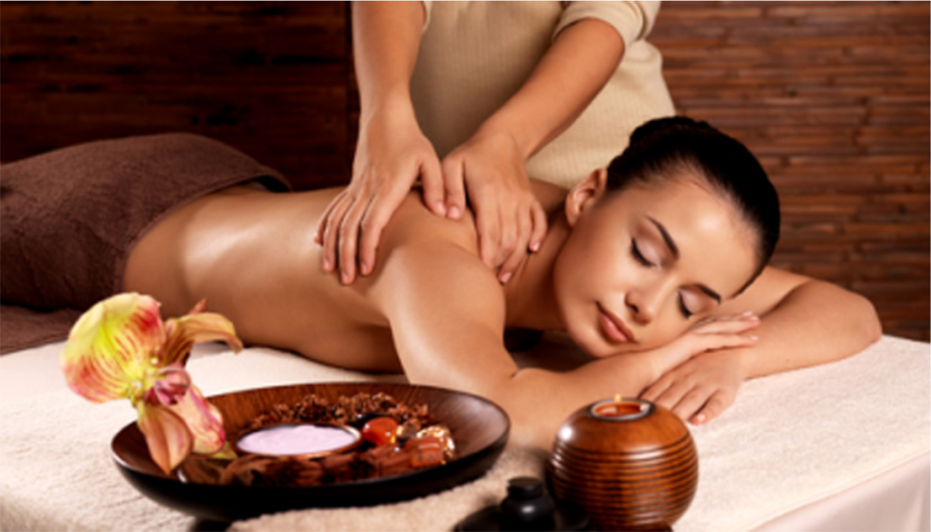 A girl is lying down happily while receiving a Thai massage