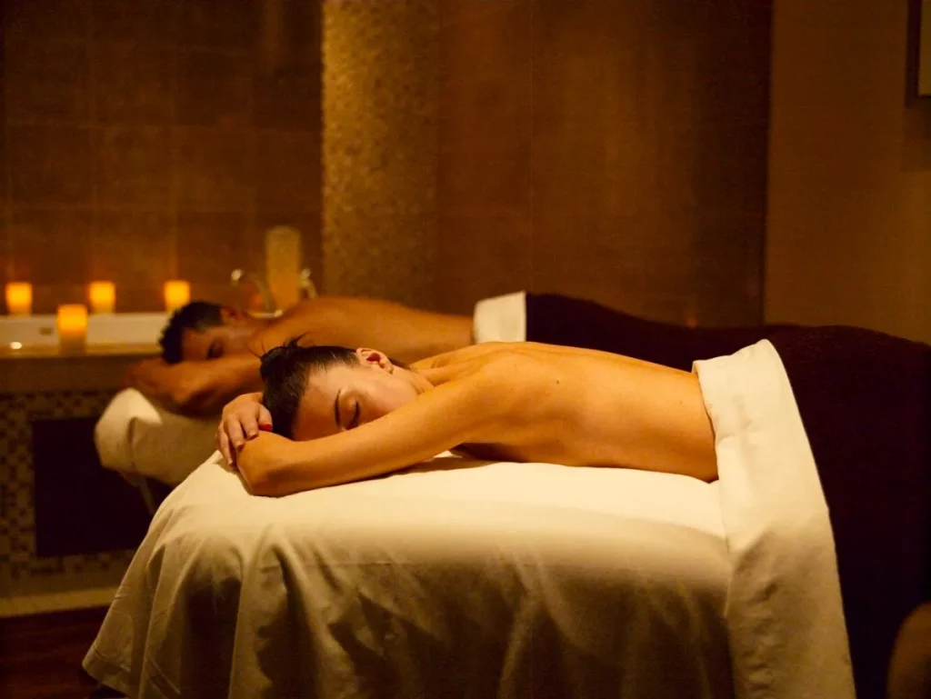 After getting a couple's massage, the male and the female lie on their stomachs