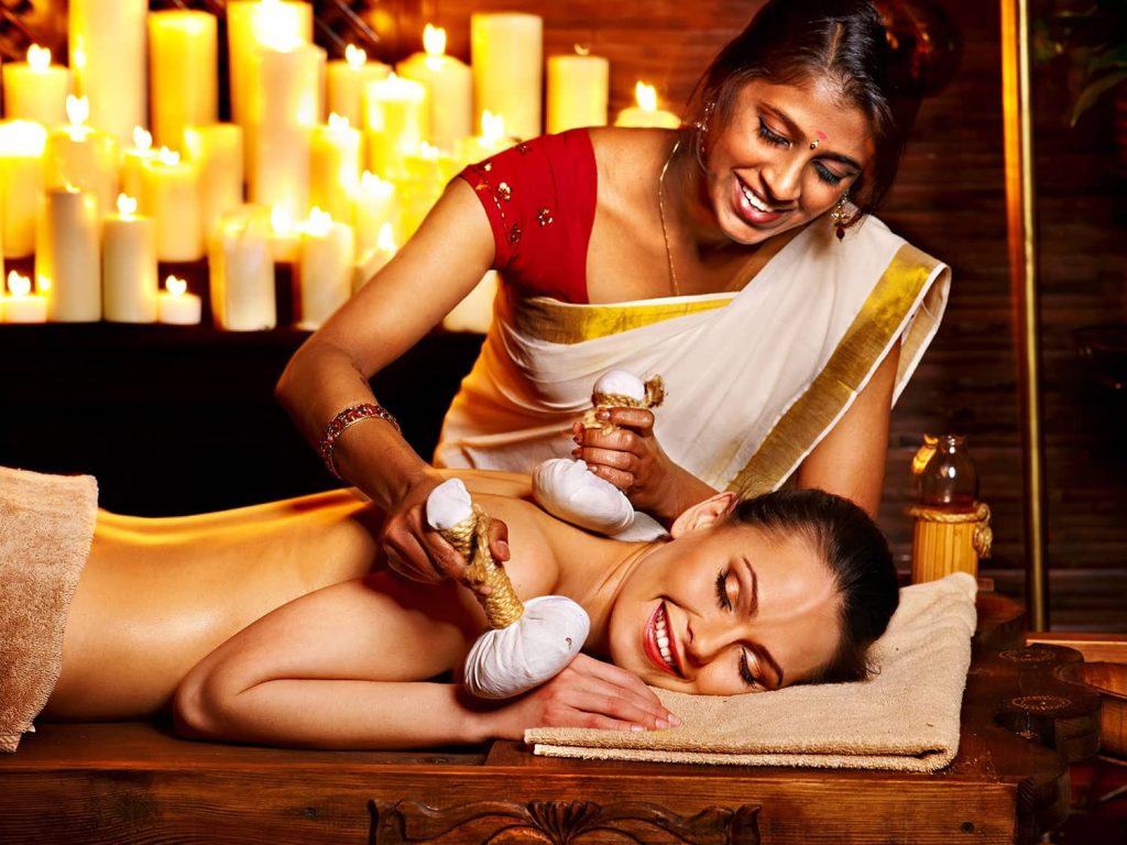 Girl lying on Stomach and getting Ayurvedic Massage